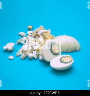 Boiled eggs cut or chopped into small pieces on a cutting Board Stock Photo