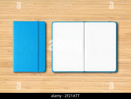 Blue closed and open lined notebooks on wooden background Stock Photo