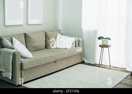The interior is in a minimalistic style. Living room with sofa. Stock Photo
