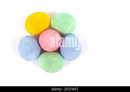 Colorful Easter flower shaped eggs isolated on white background. Painted chicken eggs, selective focus. Top view Stock Photo