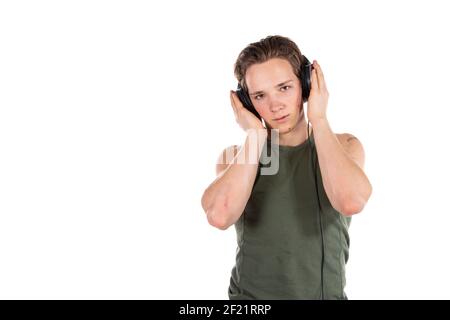Student on a white background. Young attractive guy listens to music. Stock Photo