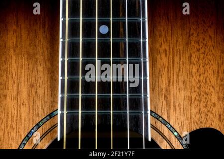 Mahogany acoustic guitar closeup view of body and fretboard Stock Photo