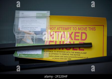 DVLA clamp an un taxed car on the highway in Preston Stock Photo