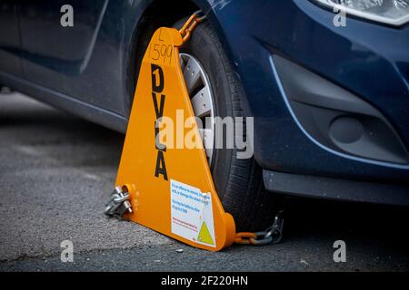 DVLA clamp an un taxed car on the highway in Preston Stock Photo
