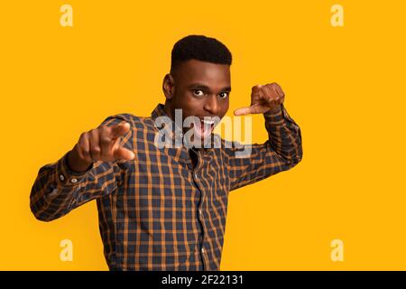 Gotcha. Excited Black Millennial Guy Pointing At Camera With Fingers Stock Photo