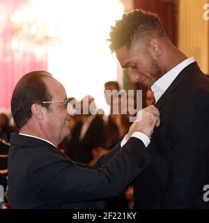 French President Francois Hollande (L) awards the Legion of Honour (Legion d'Honneur) to Olympic Super Heavy (+91kg) Boxing champion Tony Yoka at the Elysee Presidential Palace in Paris, France, on December 1, 2016 - Photo Philippe Millereau / KMSP / DPPI Stock Photo
