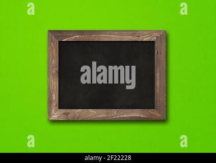 Old rustic black board isolated on a green background Stock Photo