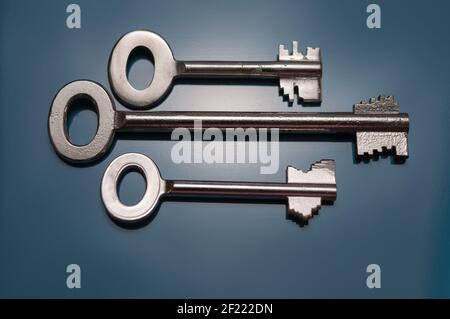 Still life with three safes keys in different designs on a black background Stock Photo