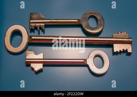 Still life with three safes keys in different designs on a black background Stock Photo