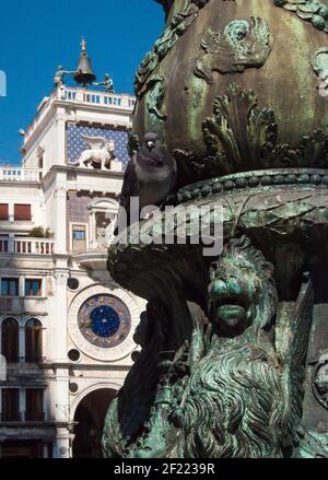 Detail of a copper fountain with a green patina in Venice. With eye-catching lion head in the foreground Stock Photo