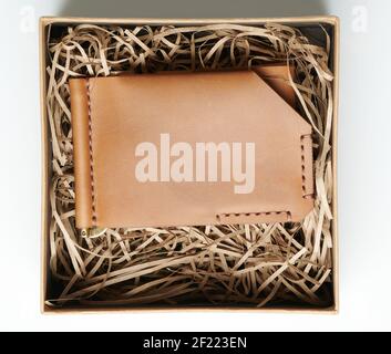 Brown leather  wallet in gift box above top view isolated Stock Photo