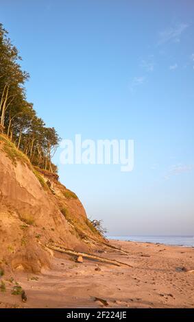 Empty beach with sand cliff at sunrise, Baltic Sea, Poland. Stock Photo