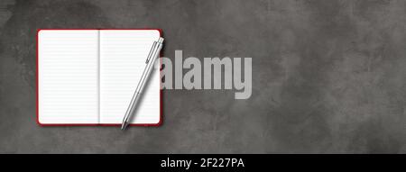 Red open lined notebook with a pen isolated on dark concrete background. Horizontal banner Stock Photo