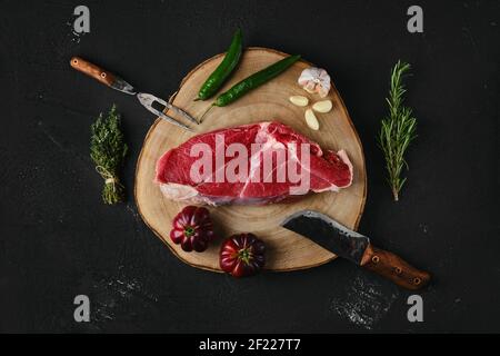 Top view of raw top sirloin beef steak on wooden cutting board Stock Photo