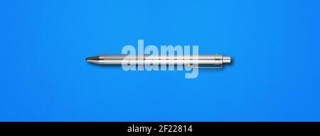 Metal pen isolated on blue background Stock Photo
