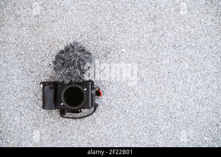 A camera with a microphone on grey background with copy space Stock Photo