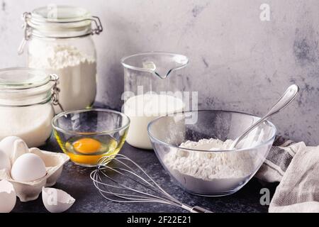 Baking background. Cooking ingredients for dough, eggs, flour, sugar, milk. Stock Photo