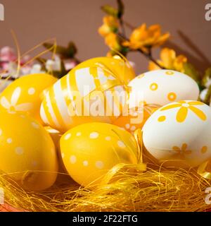 orange easter eggs over yellow straw Stock Photo