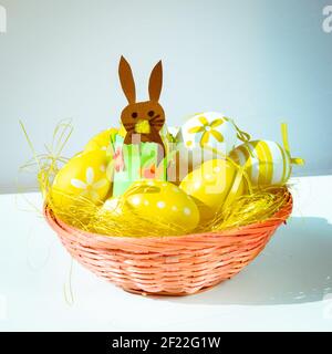 yellow easter eggs over yellow straw in the basket Stock Photo