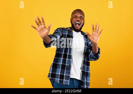 Shocked Black Guy Shouting Gesturing Stop Standing Over Yellow Background Stock Photo