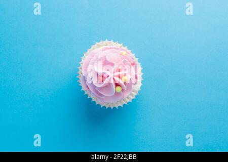 Colorful celebration background with cupcake. Minimal party concept. Top view. Stock Photo