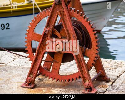 Rusty old boat winch with boat in the background Croatia Dubrovnik Stock Photo