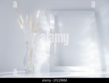 White bunny tail grass and frame on grey background, copy space, dried lagurus grass. Bunny tail grass in a vase Stock Photo