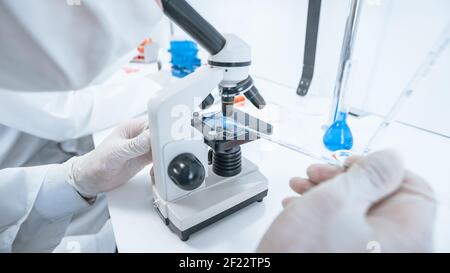 close up. scientist using a microscope in a modern laboratory. Stock Photo