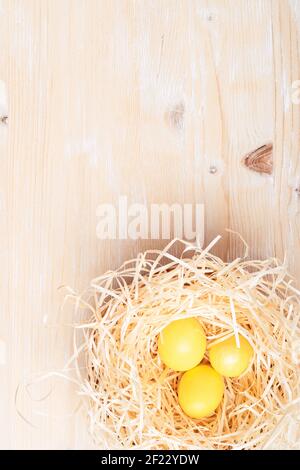 Eco-friendly Easter decor with natural, reusable, zero-waste materials, handmade dyed eggs, upcycling gift package, nest with Easter eggs on white woo Stock Photo