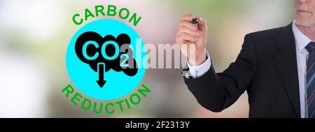 Businessman drawing a carbon reduction concept Stock Photo