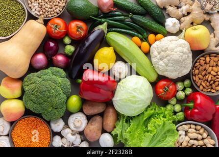 Fresh farm organic vegetables, healthy food concept, vegetables and beans, superfood and green salad, nuts and seeds, top view Stock Photo