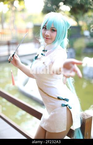 Japan anime cosplay portrait of a girl with chinese dress costume in  chinese garden Stock Photo - Alamy