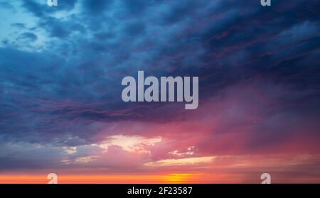 Colorful dramatic sky with clouds at sunset, nature background Stock Photo