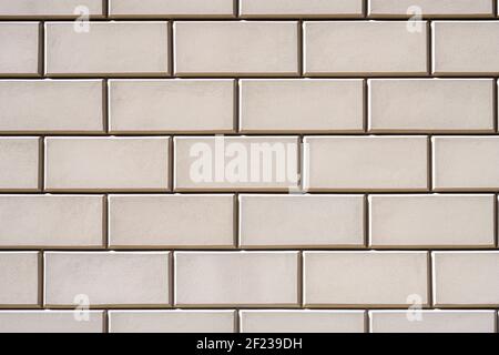 Background from a wall with rectangular beige stone slabs Stock Photo