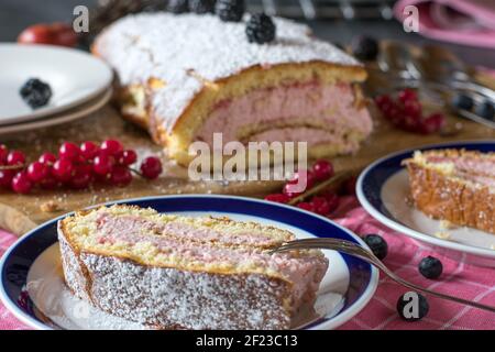A piece of jellyroll with cream filling served on a plate Stock Photo