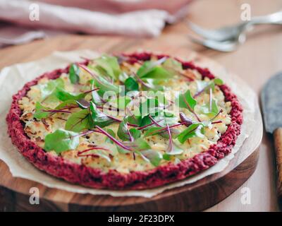 Beetroot pizza crust with fresh mangold leaves Stock Photo