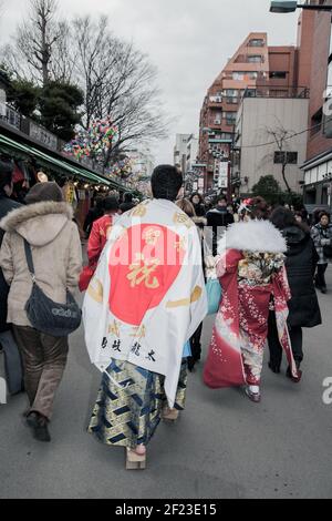 Japanese male wearing yukata and Japanese flag on Coming of Age Day (Seijin no hi) to celebrate turning 20 and becoming adults, Asakusa, Tokyo, Japan Stock Photo