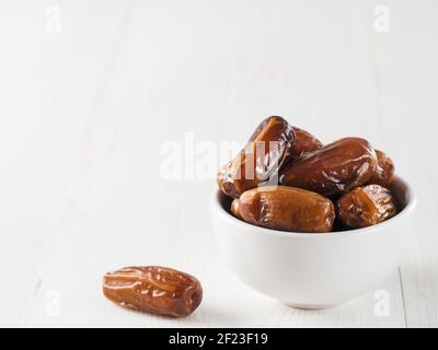 Plate of dried dates on table Stock Photo