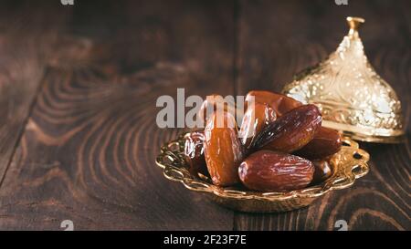 Plate of pitted dates on table Stock Photo
