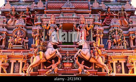 Sri Maha Mariamman Temple Facade: An intricate and colorful Hindu art and deity carvings on the facade of Sri Maha Mariamman Temple, Kuala Lumpur Stock Photo