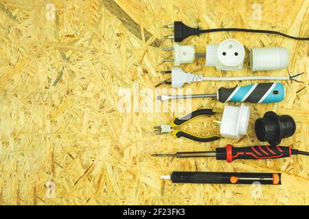 Electrical lamp holders and electrical appliances. Power tools on the table with space for text. Various electrical tools on a wooden table Stock Photo