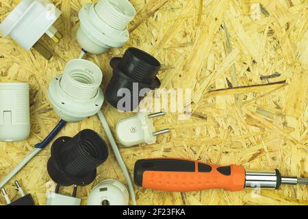 Electrical lamp holders and electrical appliances. Power tools on the table with space for text. Various electrical tools on a wooden table Stock Photo