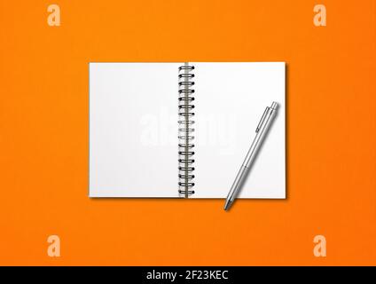 Blank open spiral notebook and pen isolated on orange Stock Photo