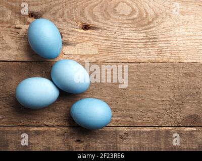 Naturally colored organic eggs on a rustic table with space for text, Easter background Stock Photo