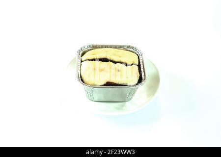 Cheesecake Brownie chocolate in Freud paper cup on white plate. Mini Tart Cheesecake Brownie yummy Bakery homemade isolate with white background. Swee Stock Photo