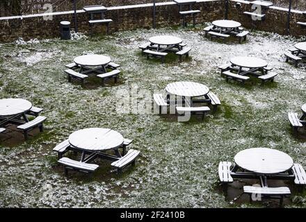 Deserted beer garden in the snow, Rye, East Sussex, England Stock Photo