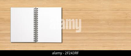 Blank open spiral notebook isolated on wooden banner Stock Photo