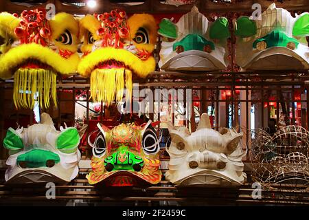 Chinese Lion & Dragon Dance Costume Heads on display Stock Photo