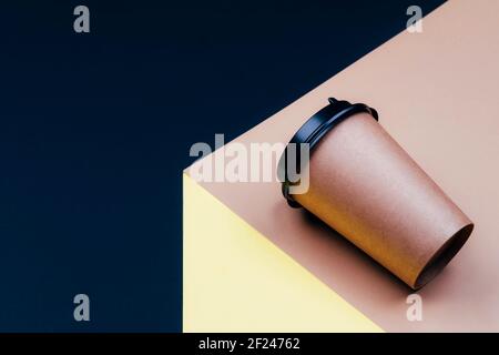 Disposable cardboard cup on a platform with space for text. Stock Photo