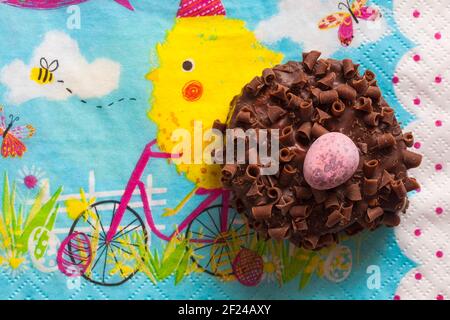 Cadbury Mini Eggs Nest Cake set on Easter serviette napkin Stock Photo